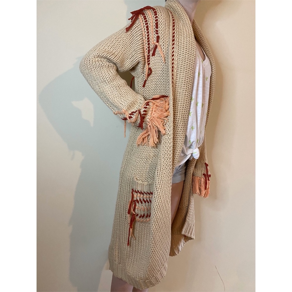 Beige knitted cardigan with red and peach accents